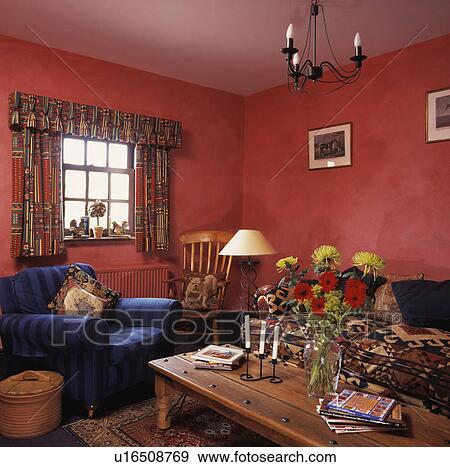 Blue armchair in traditional red living room View Large Photo Image Stock Photo - Blue armchair in traditional red living room. Fotosearch