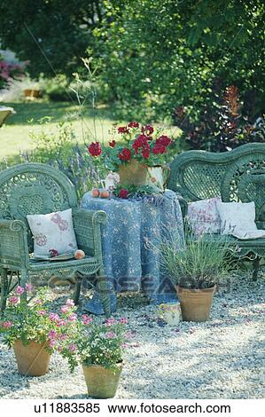 Stock Photography - BLue chairs and blue cloth on table in country garden in summer. Fotosearch