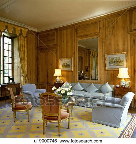 Stock Photograph - Blue sofas in panelled drawing room. Fotosearch