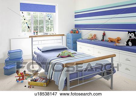 Blue striped wall and bedcover in child's modern bedroom with fitted storage unit View Large Photo Image Stock Photo - Blue striped wall and bedcover in child's modern bedroom with fitted storage unit. Fotosearch