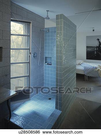 Blue tiled ensuite shower room in modern white bedroom View Large Photo Image Stock Photograph - Blue tiled ensuite shower room in modern white bedroom. Fotosearch