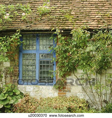 Blue window on traditional brick country cottage View Large Photo Image Stock Image - Blue window on traditional brick country cottage. Fotosearch