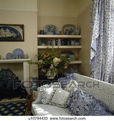 Blue+white floral cushions on sofa in traditional living room View Large Photo Image Stock Image - Blue+white floral cushions on sofa in traditional living room. Fotosearch