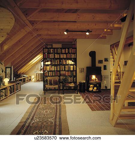 Stock Image - Bookshelves in modern attic living room. Fotosearch