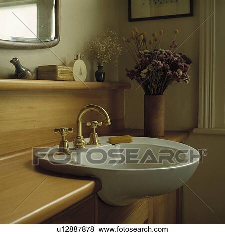 Brass taps on circular white basin built into pine vanity unit View Large Photo Image Stock Photo - Brass taps on circular white basin built into pine vanity unit. Fotosearch