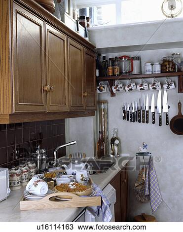 Breakfast tray on worktop in kitchen with wood fitted cupboards and knife storage on wall View Large Photo Image Stock Image - Breakfast tray on worktop in kitchen with wood fitted cupboards and knife storage on wall. Fotosearch