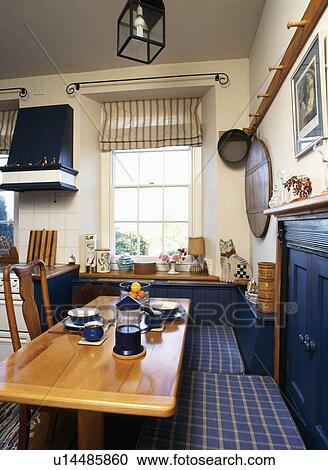 Cafetiere and cups on wooden table with blue check cushions on banquette in traditional kitchen View Large Photo Image Stock Image - Cafetiere and cups on wooden table with blue check cushions on banquette in traditional kitchen. Fotosearch