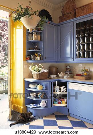 Cat beside doorway in blue fitted kitchen with blue+white chequerboard floor View Large Photo Image Stock Photo - Cat beside doorway in blue fitted kitchen with blue+white chequerboard floor. Fotosearch