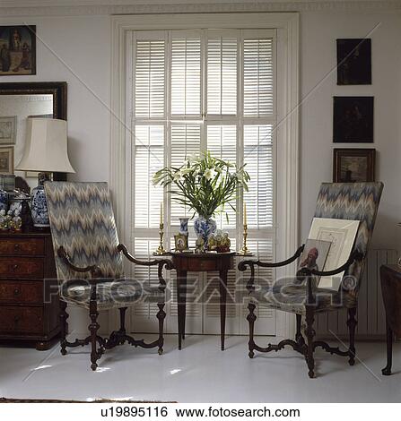 Chairs and table in front of window View Large Photo Image Stock Photograph - Chairs and table in front of window. Fotosearch