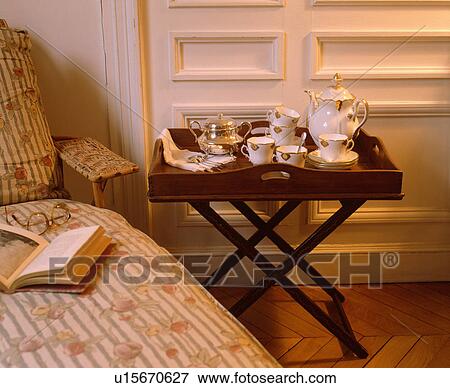 China coffee pot and cups on antique Butler's Tray beside chaiselongue with quilted cover View Large Photo Image Stock Photo - China coffee pot and cups on antique Butler's Tray beside chaiselongue with quilted cover. Fotosearch