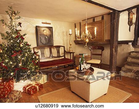 Christmas tree in small country living room View Large Photo Image Stock Photo - Christmas tree in small country living room. Fotosearch