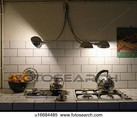 Chrome coffee jug on tray beside hob with stainless steel kettle below chrome wall lights View Large Photo Image Stock Photography - Chrome coffee jug on tray beside hob with stainless steel kettle below chrome wall lights. Fotosearch