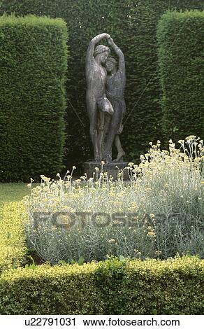 Classical statues in alcove in clipped hedge in large country garden View Large Photo Image Stock Image - Classical statues in alcove in clipped hedge in large country garden. Fotosearch