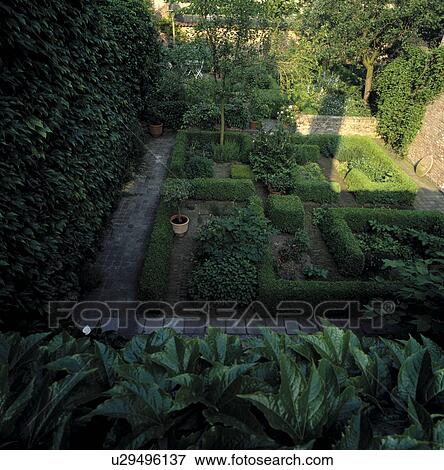 Clipped hedges in formal country garden in summer View Large Photo Image Stock Photo - Clipped hedges in formal country garden in summer. Fotosearch
