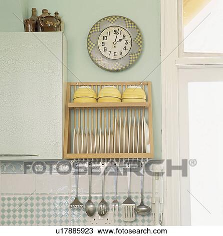 Clock above plate rack with stainless steel utensils stored below View Large Photo Image Stock Image - Clock above plate rack with stainless steel utensils stored below. Fotosearch