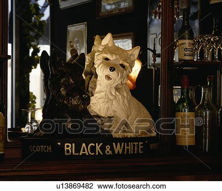 Stock Image - Close-up of Black+White whiskey vintage plaster dogs. Fotosearch