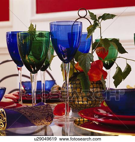 Close-up of blue and green wine glasses on dining table with red plates and blue bowls View Large Photo Image Stock Photo - Close-up of blue and green wine glasses on dining table with red plates and blue bowls. Fotosearch