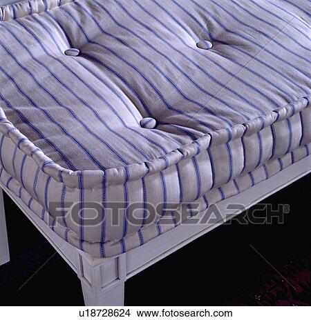 Close-up of blue and white striped mattress on white bedstead View Large Photo Image Picture - Close-up of blue and white striped mattress on white bedstead. Fotosearch