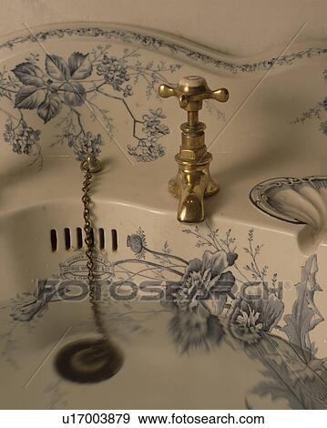 Close-up of blue floral-patterned white basin with brass tap and plug View Large Photo Image Stock Photo - Close-up of blue floral-patterned white basin with brass tap and plug. Fotosearch