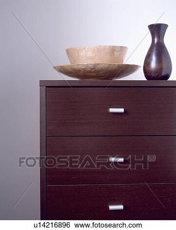 Close-up of bowl and vase on chest-of-drawers View Large Photo Image Stock Photograph - Close-up of bowl and vase on chest-of-drawers. Fotosearch