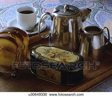 Close-up of chrome teapot and jug on tray with floral tin and toast-rack View Large Photo Image Stock Image - Close-up of chrome teapot and jug on tray with floral tin and toast-rack. Fotosearch
