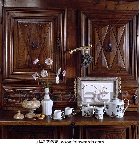 Stock Photograph - Close-up of collection of antique china on carved wooden dresser. Fotosearch