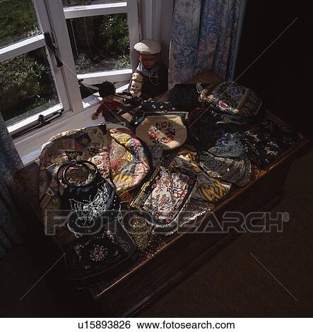 Close-up of collection of antique embroidered purses and bags on table in front of open window View Large Photo Image Stock Photograph - Close-up of collection of antique embroidered purses and bags on table in front of open window. Fotosearch