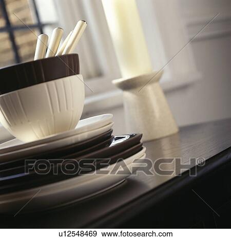Close-up of cream and black bowls and plates on dining table View Large Photo Image Stock Photo - Close-up of cream and black bowls and plates on dining table. Fotosearch