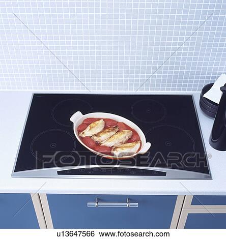 Close-up of dish of food on black halogen hob View Large Photo Image Stock Photograph - Close-up of dish of food on black halogen hob . Fotosearch