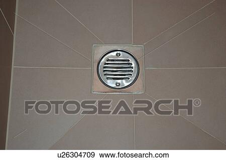 Stock Photo - Close up of drain in bathroom floor. Fotosearch