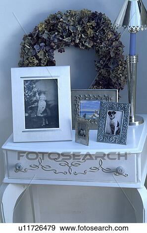 Close-up of dried flower wreath and photographs on small white table View Large Photo Image Stock Photo - Close-up of dried flower wreath and photographs on small white table. Fotosearch