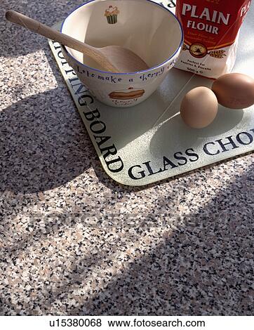Close-up of eggs and ingredients on glass chopping board on granite worktop View Large Photo Image Stock Photo - Close-up of eggs and ingredients on glass chopping board on granite worktop. Fotosearch