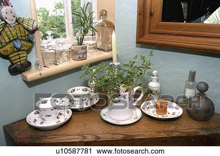 Close-up of floral patterned china cups on triangular wooden shelf in dining room View Large Photo Image Stock Image - Close-up of floral patterned china cups on triangular wooden shelf in dining room. Fotosearch