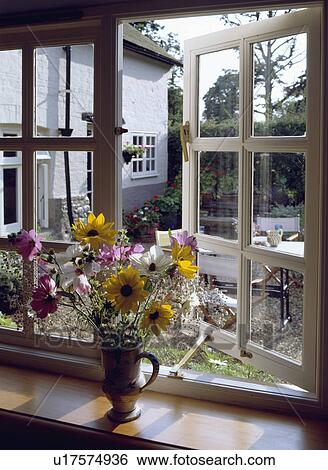 Close-up of fresh flower arrangement on casement window sill View Large Photo Image Stock Photograph - Close-up of fresh flower arrangement on casement window sill. Fotosearch