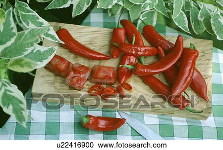 Close-up of fresh red chillies on chopping board View Large Photo Image Stock Image - Close-up of fresh red chillies on chopping board. Fotosearch