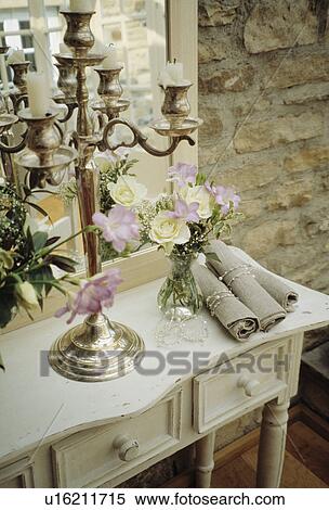 Close-up of grey linen napkins and silver candelabra on grey wooden console table View Large Photo Image Stock Photography - Close-up of grey linen napkins and silver candelabra on grey wooden console table. Fotosearch