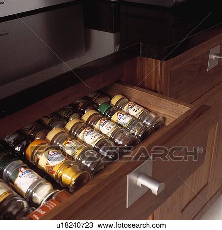Close-up of herbs and spices in glass jars stored in open drawer View Large Photo Image Stock Image - Close-up of herbs and spices in glass jars stored in open drawer. Fotosearch