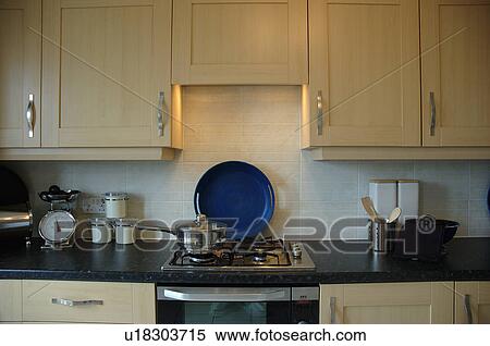 Close-up of light wood cupboards and gas hob in modern kitchen View Large Photo Image Stock Photography - Close-up of light wood cupboards and gas hob in modern kitchen. Fotosearch