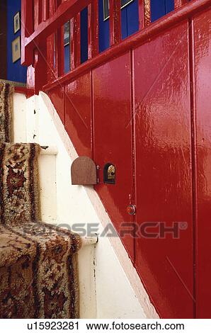 Close up of miniature door in red panelling beside cottage stairs View Large Photo Image Stock Image - Close up of miniature door in red panelling beside cottage stairs. Fotosearch