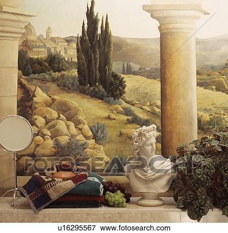 Stock Photo - Close-up of mirror and classical bust on tiled shelf below trompe l'oiel mural of Tuscan landscape. Fotosearch