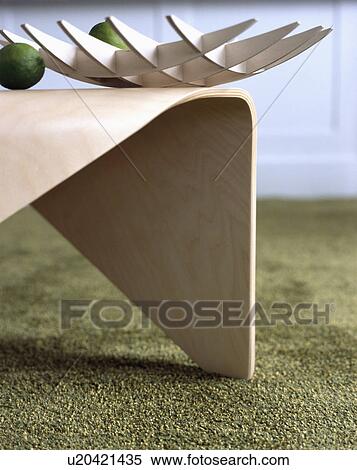Stock Photography - Close-up of modern bowl on moulded plywood table. Fotosearch