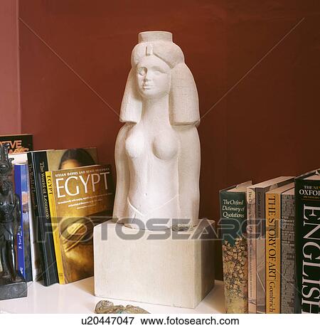 Close-up of modern Egyptian statue bust on bookshelf View Large Photo Image Stock Photo - Close-up of modern Egyptian statue bust on bookshelf. Fotosearch