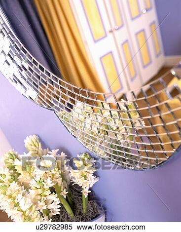 Close up of modern mosaic mirror hung on a purple painted wall View Large Photo Image Stock Photography - Close up of modern mosaic mirror hung on a purple painted wall. Fotosearch