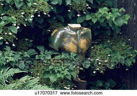 Stock Photo - Close-up of modern sculpture in the garden. Fotosearch