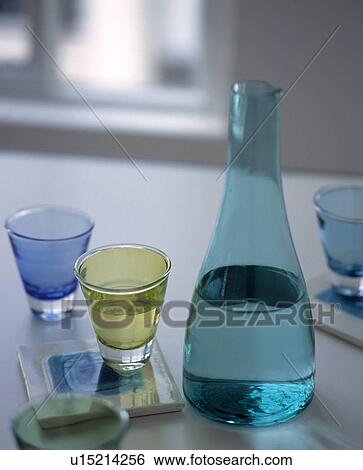 Close up of modern turquoise glass decanter with green and blue glasses View Large Photo Image Stock Photograph - Close up of modern turquoise glass decanter with green and blue glasses. Fotosearch