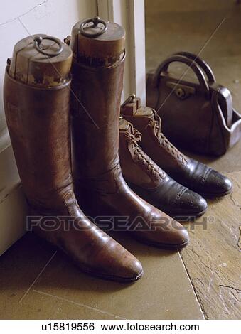 Close-up of old leather riding boots with leather bag View Large Photo Image Stock Photograph - Close-up of old leather riding boots with leather bag. Fotosearch