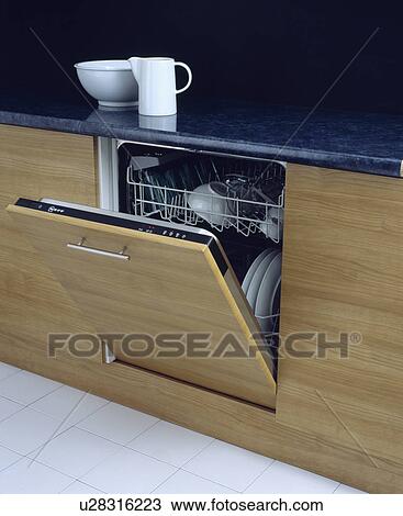 Close-up of open fitted dishwasher below white jug and bowl on black worktop View Large Photo Image Stock Image - Close-up of open fitted dishwasher below white jug and bowl on black worktop . Fotosearch
