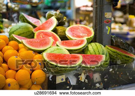 Close up of oranges and halved watermelons on Spanish market stall View Large Photo Image Picture - Close up of oranges and halved watermelons on Spanish market stall. Fotosearch