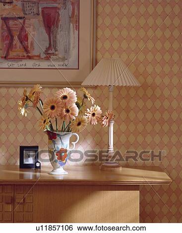 Close-up of pink gerberas and lamp against peach checked wallpaper View Large Photo Image Stock Photograph - Close-up of pink gerberas and lamp against peach checked wallpaper. Fotosearch