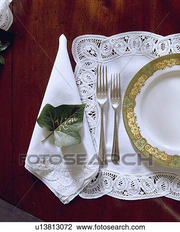 Close up of plate on white lace placemat with matching napkin with ivy leaf placetag View Large Photo Image Stock Image - Close up of plate on white lace placemat with matching napkin with ivy leaf placetag. Fotosearch